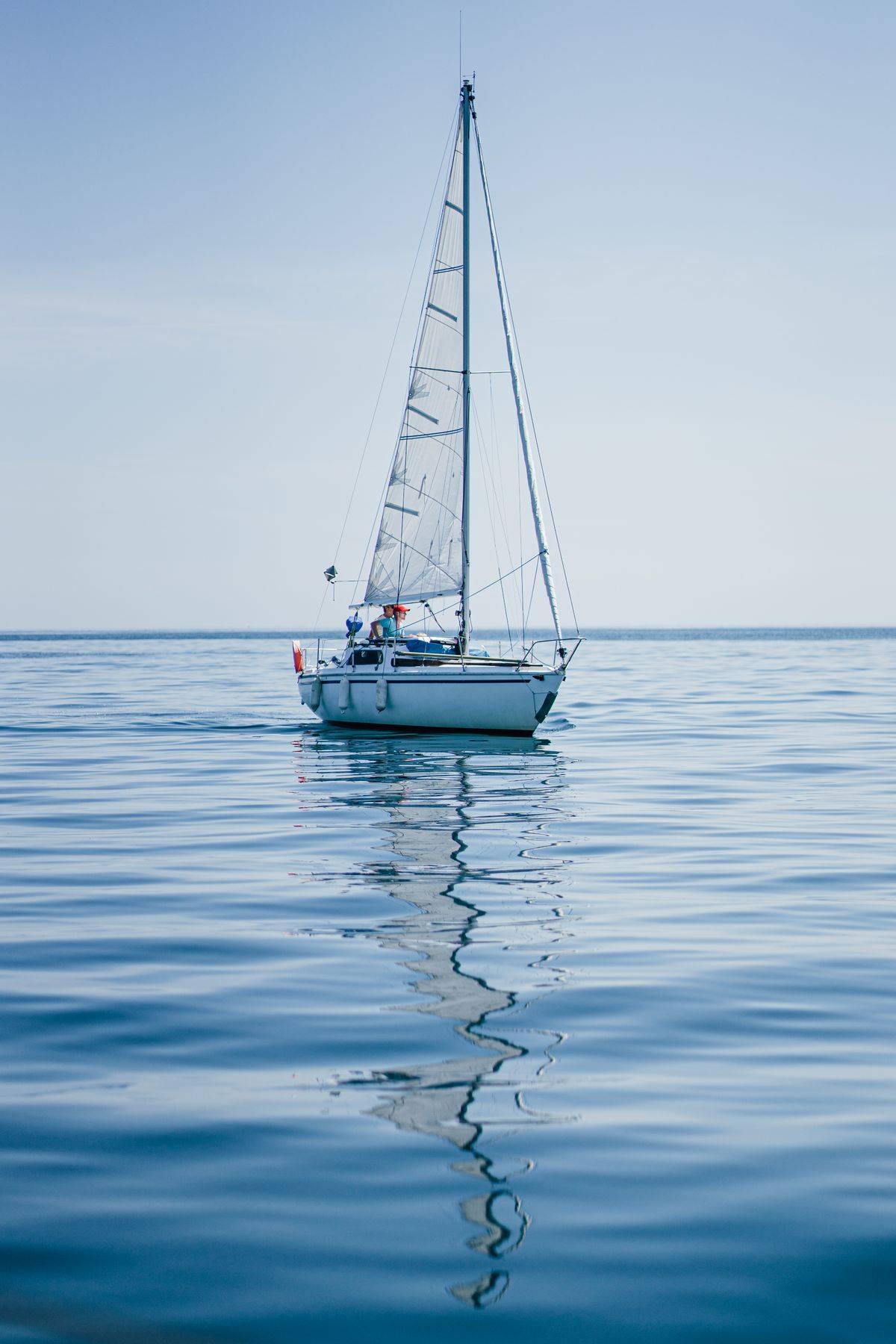 Sailboat gliding across calm water — find a boat name as smooth as this